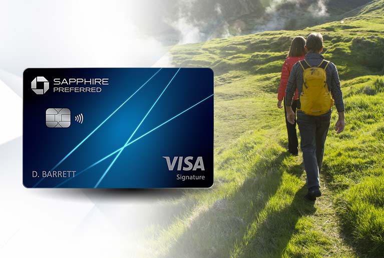 CHASE Sapphire Preferred (Registered Trademark) card to the left of a male and female hiking on green hills along a steaming river